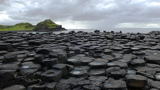 black rock formations under cloudy sky thumbnail