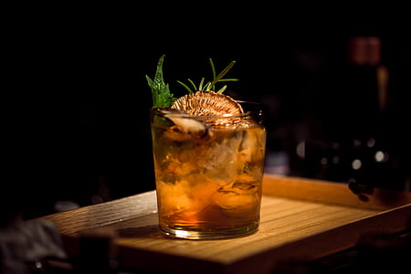 clear shot glass on brown wooden tray thumbnail