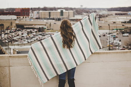 woman spreading scarf on her back thumbnail