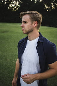 man standing on grass field thumbnail