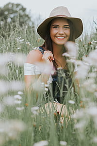 shift-tilt lens photography of woman smiling in grass field thumbnail