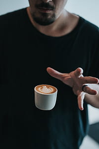 man's hand near floating cup thumbnail