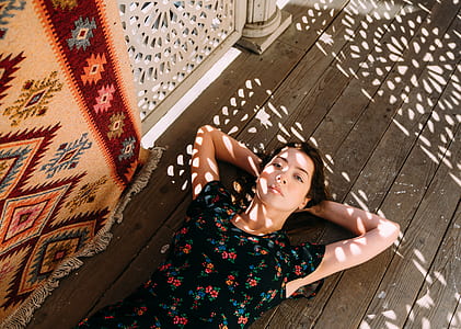 woman lying on brown wooden floor thumbnail