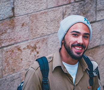 man standing near wall while smiling thumbnail