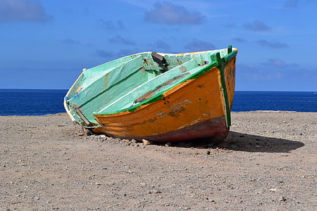 green and brown boat on shore during daytime thumbnail