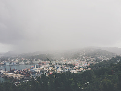 aerial photography of city near sea and mountain thumbnail