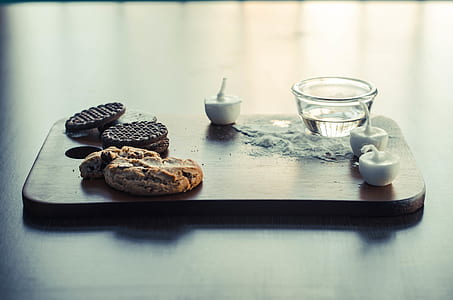 baked cookies near tealight candles and bowl on chopping board thumbnail