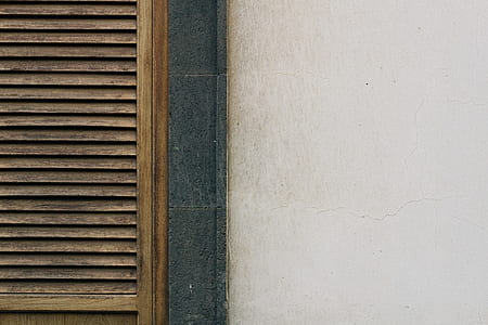 closed brown wooden louvered door thumbnail