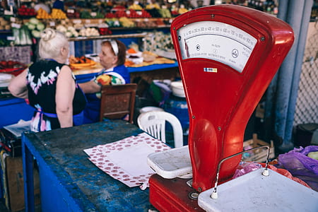 two women sitting and standing beside table thumbnail