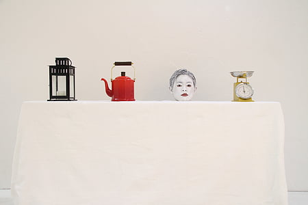 red teapot beside candle lantern thumbnail