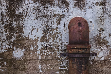 photo of rusty water pipe attached on wall thumbnail