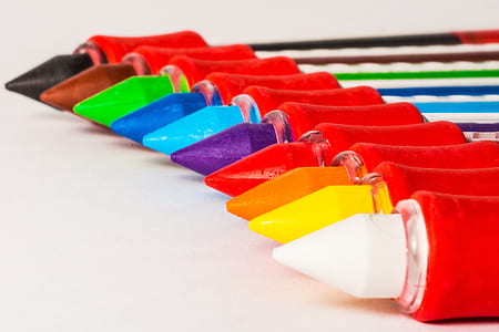 assorted-color crayons lined up closeup photo thumbnail