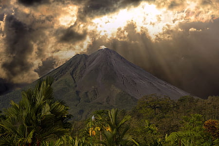 brown mountain under cloudy sky thumbnail