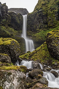 waterfalls between rock formations at daytime thumbnail