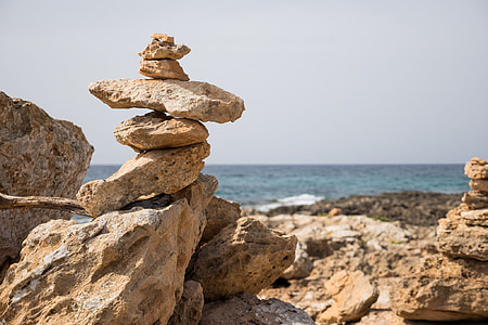 brown stone formation near beach at daytime thumbnail