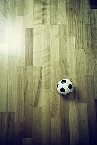 white and black soccer ball on parquet wood flooring thumbnail