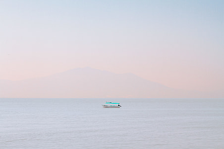 white boat sailing on ocean during daytime thumbnail