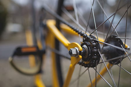 yellow bicycle on gray concrete surface during daytime thumbnail