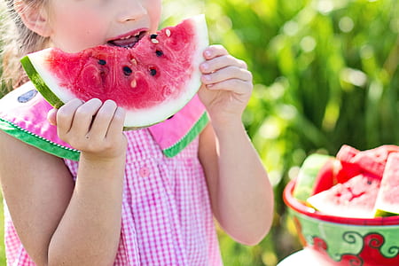girl holding watermelon during daytime thumbnail