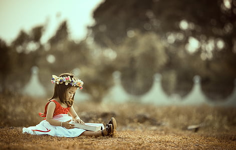 girl wearing red dress on ground during daytime thumbnail