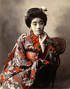 geisha sitting on brown rattan armchair thumbnail