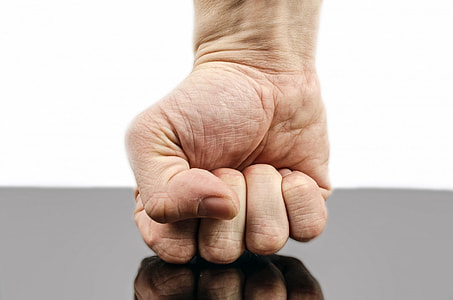 person's right fist on black surface thumbnail