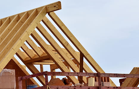 brown wooden house under cloudy blue sky thumbnail