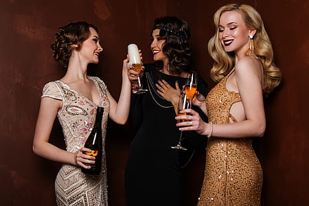 three woman holding clear wine glasses thumbnail