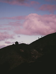 silhouette photography of mountain under blue sky thumbnail