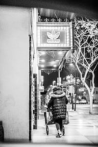 grayscale photo of person pushing cart thumbnail