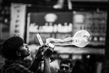Man Playing Bubbles Grayscale Photo thumbnail