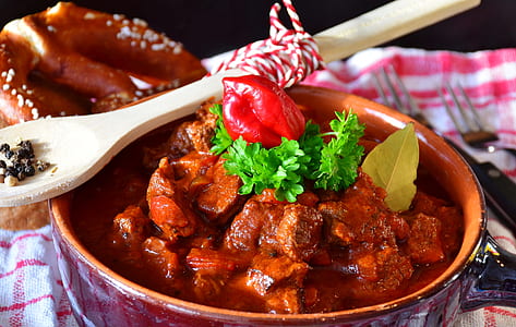 red ceramic casserole filled with meat viand thumbnail