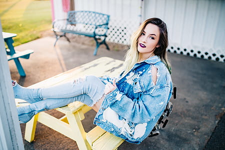 woman sitting on yellow picnic table thumbnail