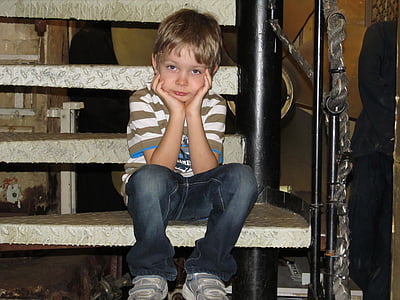 boy in black jeans sitting on stairs thumbnail
