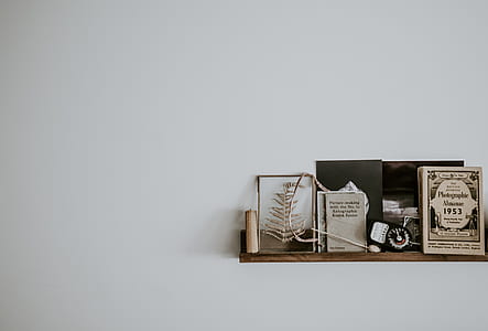 assorted table decors on brown wooden floating shelf thumbnail