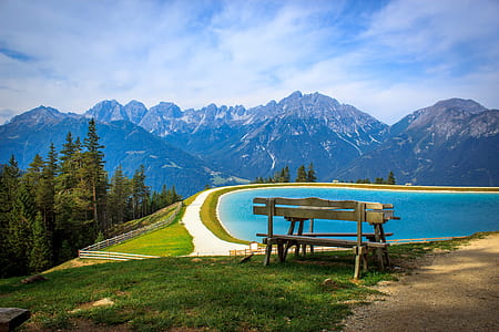 brown wooden bench near body of water painting thumbnail
