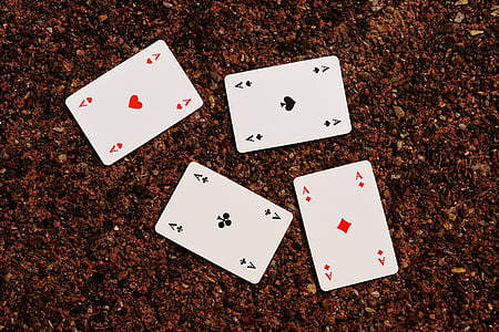 four Ace playing card on brown surface thumbnail