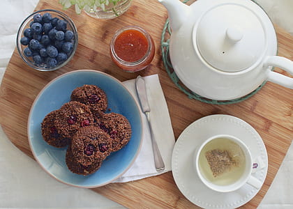 cookies on blue ceramic plate near white kettle and grey stainless steel knife thumbnail