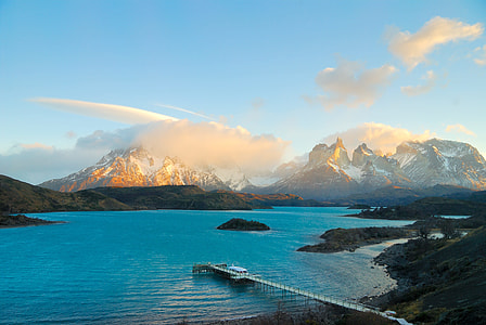 body of water near mountain at daytime thumbnail