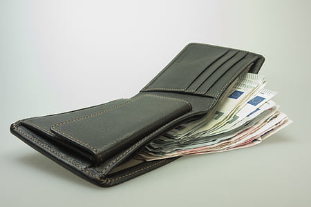black leather bifold wallet filled with banknotes thumbnail