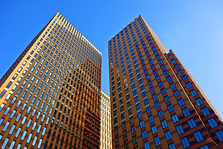 worm view photography of two brown buildings during daytime thumbnail