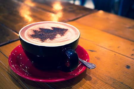 black ceramic mug on red ceramic saucer plate thumbnail