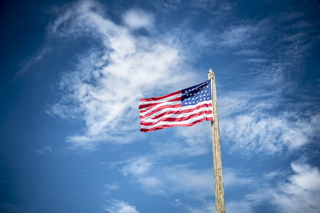 USA flag under white clouds during daytime thumbnail