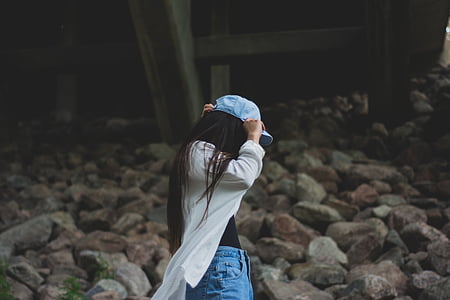 woman wearing white cardigan and blue cap thumbnail