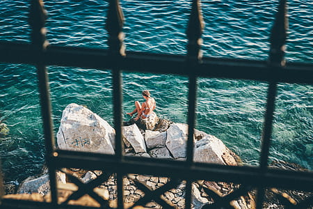 woman sitting on seaside rock thumbnail