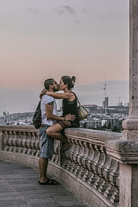 man and woman kissing during daytime thumbnail