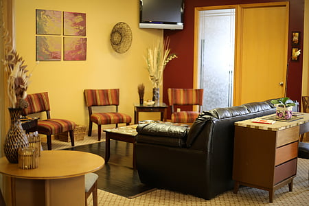 black leather couch and brown wooden coffee table in front thumbnail