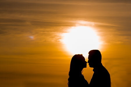 silhouette of man and woman facing each other thumbnail