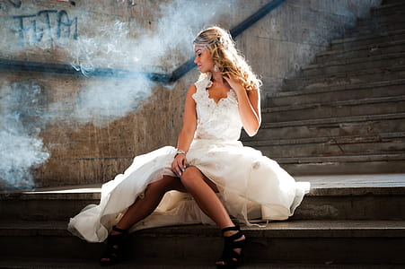 woman wearing white dress sitting on stair case thumbnail