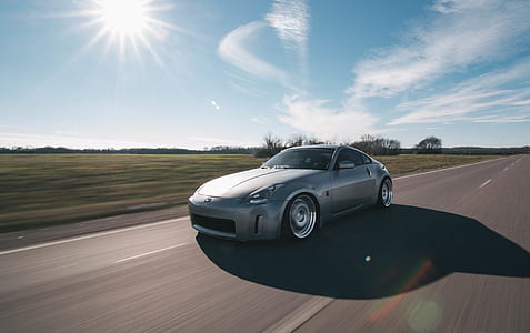 gray sports car at the road thumbnail